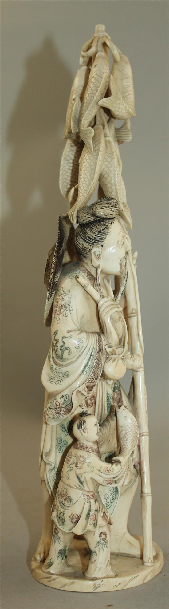 A large Chinese ivory group of a fisherman and two children, first half 20th century, 30.5cm